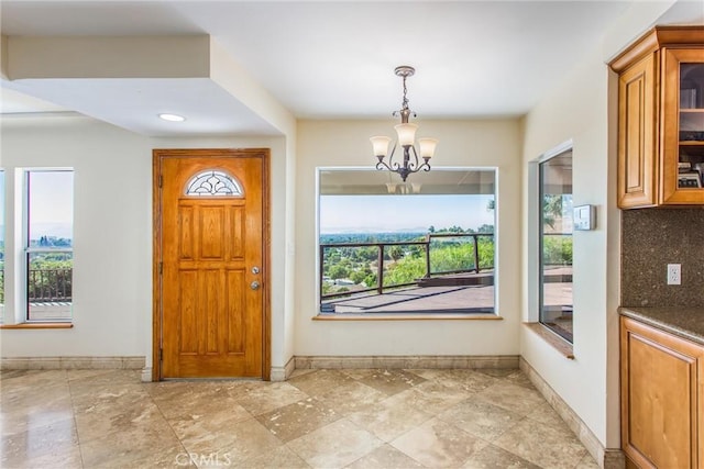 entrance foyer featuring a chandelier and a wealth of natural light