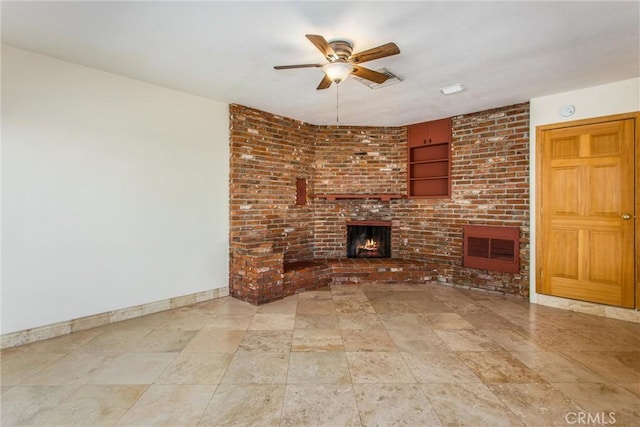 unfurnished living room featuring ceiling fan and a brick fireplace