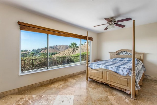 bedroom with a mountain view and ceiling fan