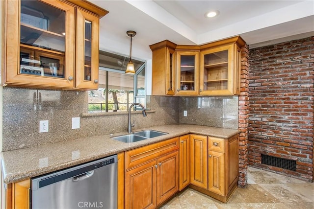 kitchen with dishwasher, tasteful backsplash, light stone counters, and sink