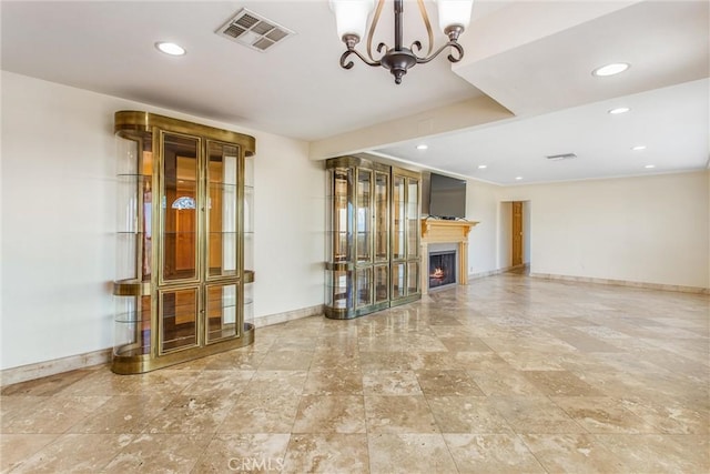 unfurnished living room featuring an inviting chandelier