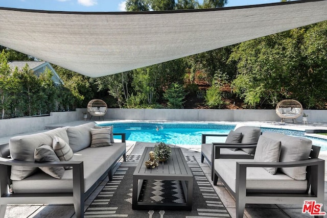 view of pool with an outdoor hangout area