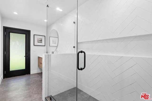 bathroom featuring walk in shower and vanity