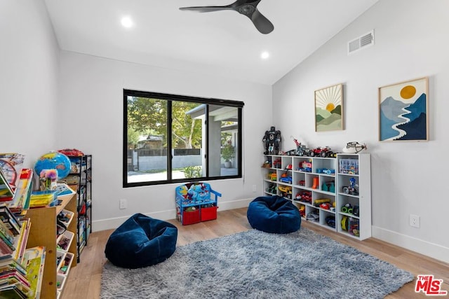 rec room featuring wood-type flooring, vaulted ceiling, and ceiling fan