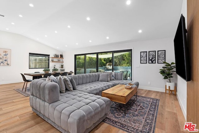 living room with lofted ceiling and light hardwood / wood-style floors