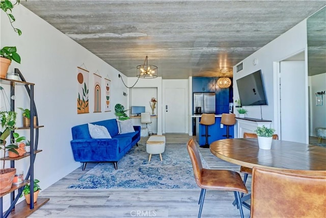 living room with an inviting chandelier and hardwood / wood-style flooring