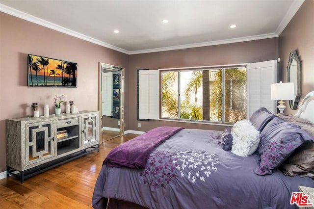 bedroom featuring ornamental molding and hardwood / wood-style floors