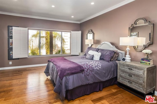 bedroom featuring hardwood / wood-style flooring and crown molding