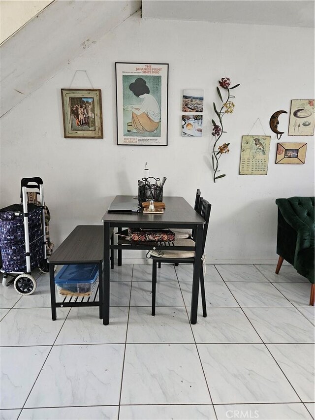 dining room with lofted ceiling