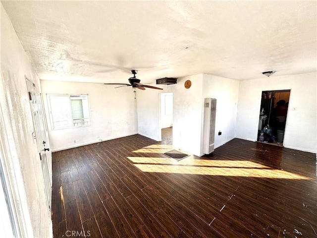 interior space with ceiling fan and dark hardwood / wood-style flooring