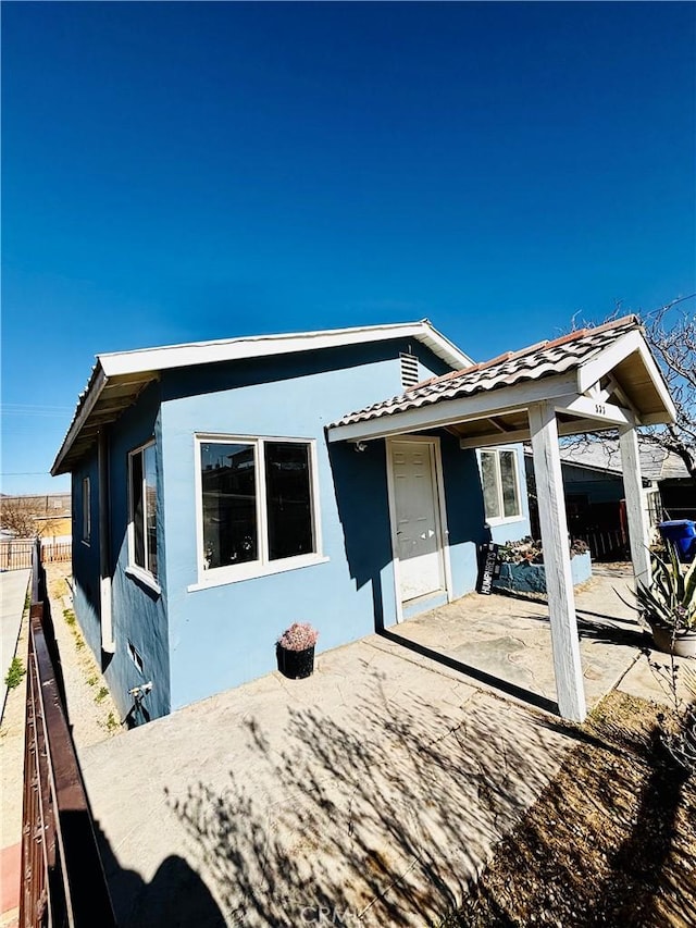 rear view of house featuring a patio