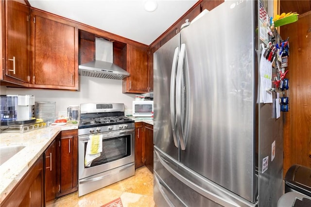 kitchen featuring appliances with stainless steel finishes, light stone counters, and wall chimney exhaust hood