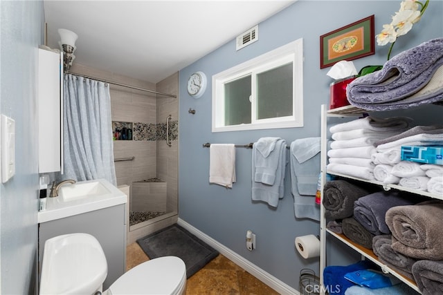 bathroom with sink, a shower with shower curtain, and toilet