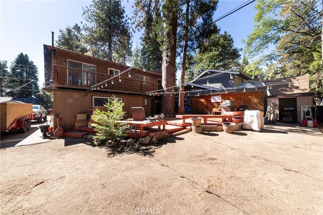 back of house with a patio and a balcony