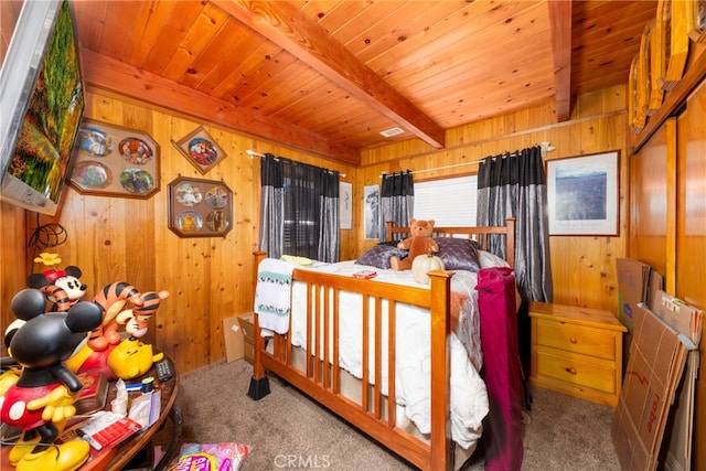 bedroom featuring beam ceiling, wooden walls, wooden ceiling, and carpet