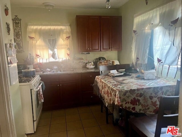 kitchen featuring gas range gas stove and tile patterned flooring