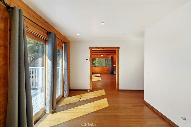 corridor with light hardwood / wood-style floors