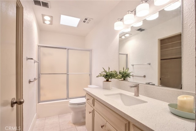 bathroom featuring tile patterned floors, enclosed tub / shower combo, visible vents, and vanity