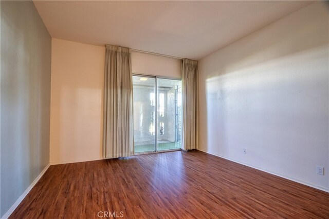 unfurnished room featuring hardwood / wood-style flooring