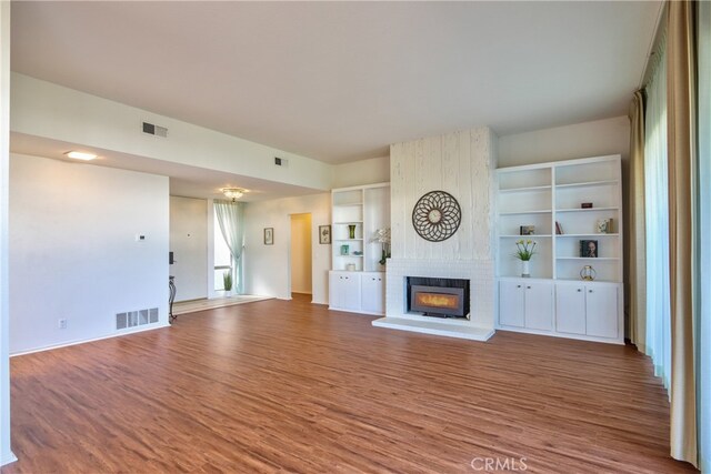 unfurnished living room featuring hardwood / wood-style flooring and a fireplace