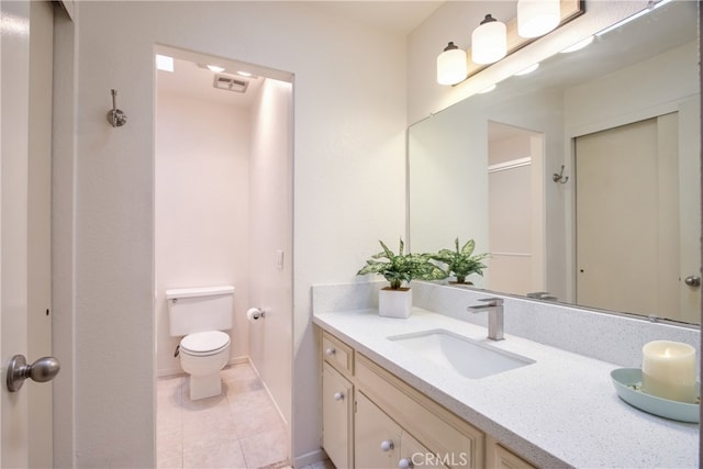 bathroom featuring baseboards, visible vents, toilet, tile patterned floors, and vanity