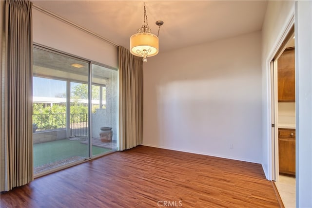 empty room featuring baseboards and wood finished floors