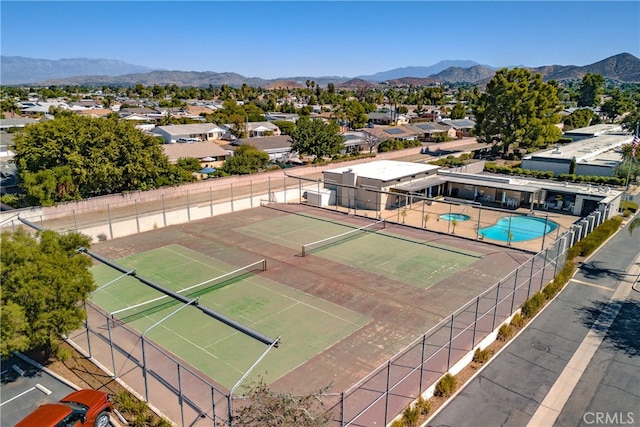 view of tennis court featuring a mountain view