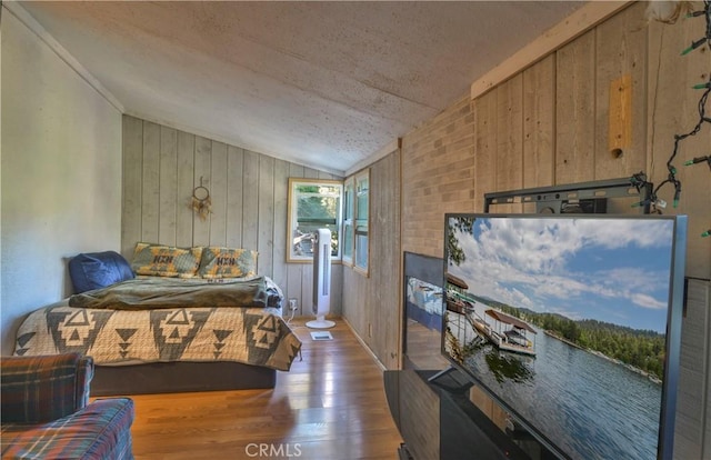 794 Virginia Ct, Lake Arrowhead, CA 92352 - bedroom with vaulted ceiling, wood finished floors, wood walls, and a textured ceiling