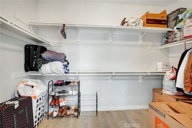 walk in closet featuring light hardwood / wood-style flooring