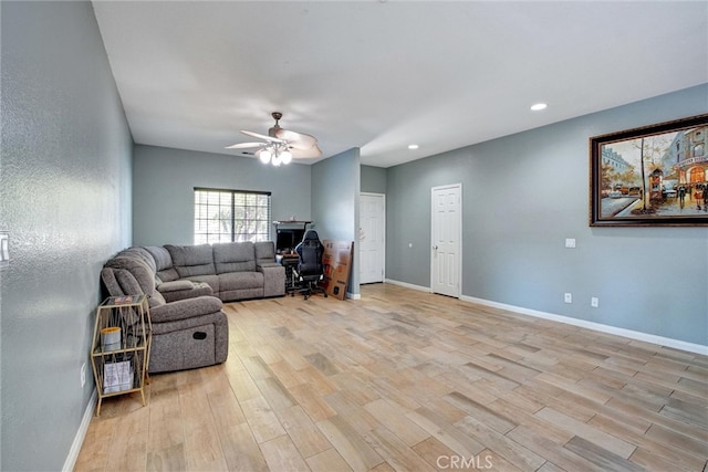 living room with light wood-type flooring and ceiling fan