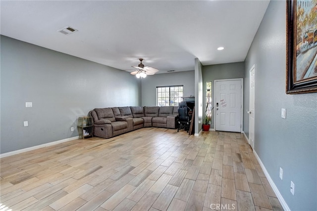 unfurnished living room with ceiling fan and light hardwood / wood-style floors