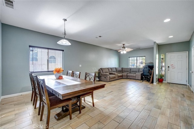 dining space with light hardwood / wood-style floors and ceiling fan