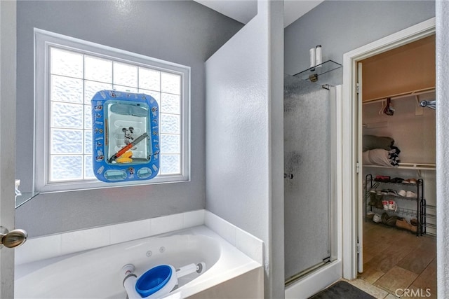 bathroom featuring wood-type flooring and independent shower and bath