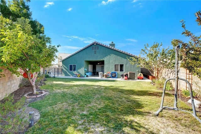 back of property with cooling unit, a lawn, and a patio area