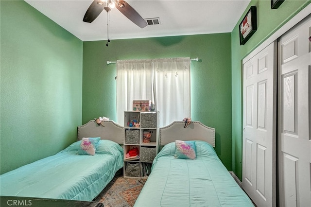 bedroom with ceiling fan and a closet