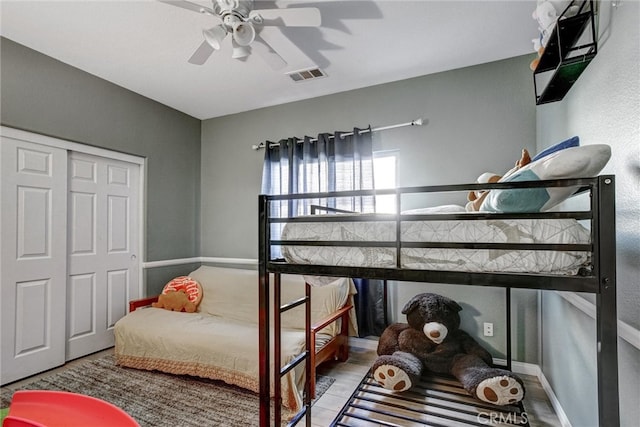 bedroom featuring ceiling fan, hardwood / wood-style flooring, and a closet