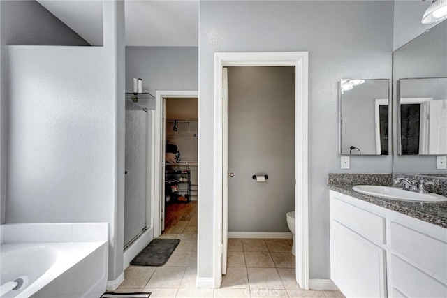 full bathroom with toilet, tile patterned flooring, vanity, and shower with separate bathtub