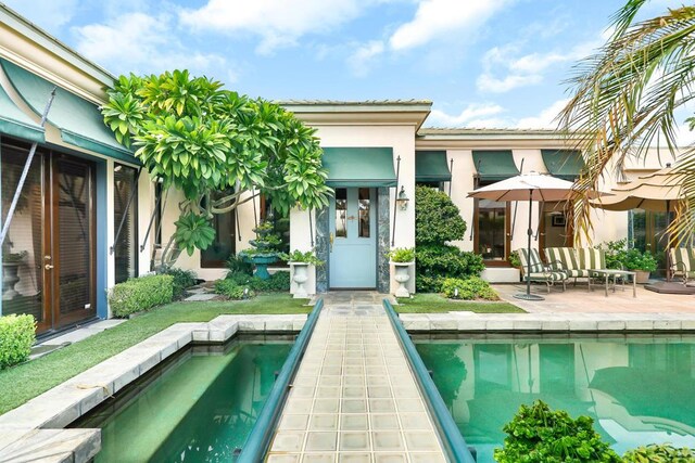 rear view of house with a patio area and outdoor lounge area