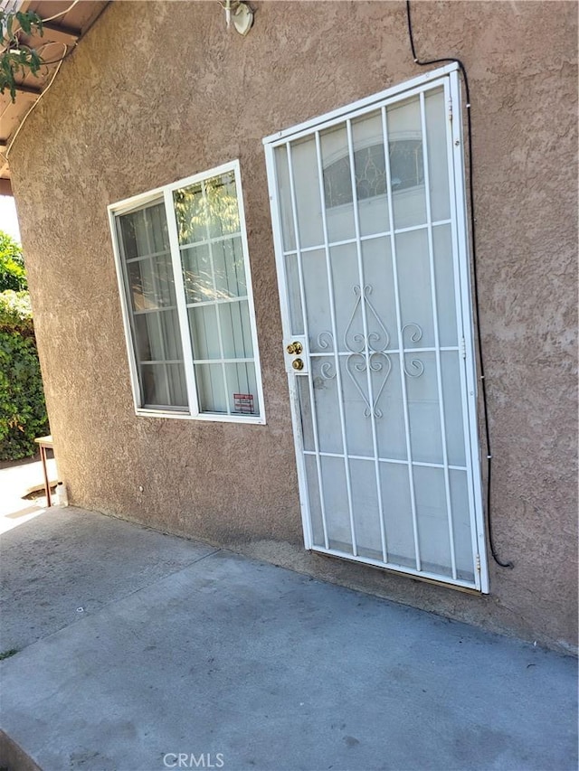 property entrance with a patio area