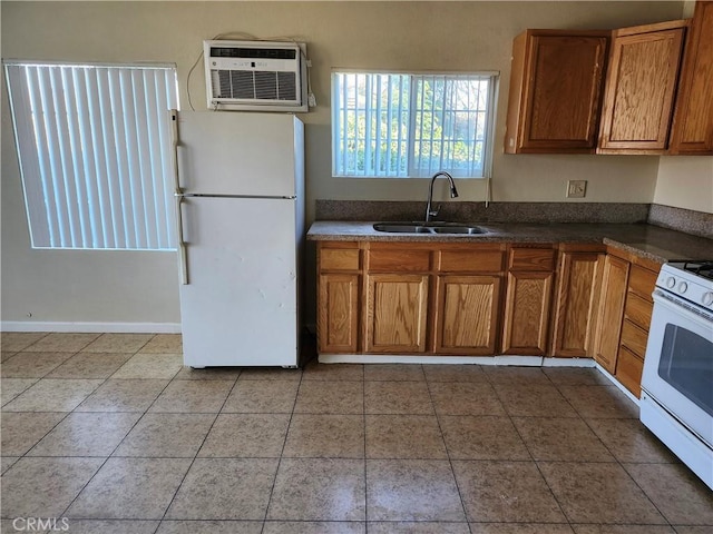 kitchen featuring sink, white appliances, a wall mounted air conditioner, and light tile patterned floors