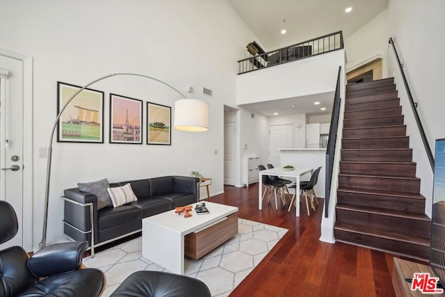 living room featuring hardwood / wood-style floors and high vaulted ceiling