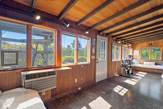 sunroom featuring lofted ceiling with beams, an AC wall unit, and wooden ceiling