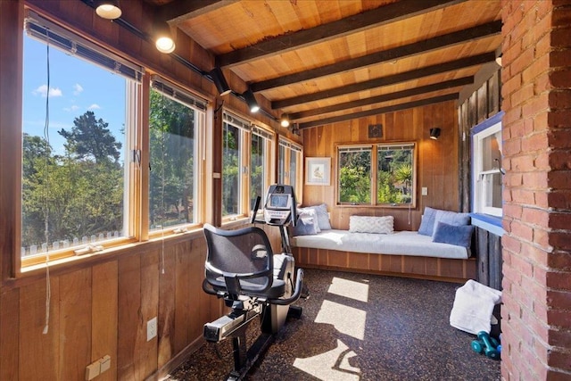 sunroom / solarium featuring lofted ceiling with beams and wooden ceiling