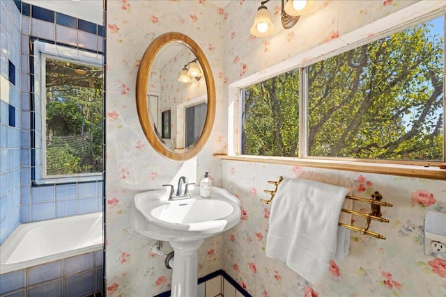 bathroom with a relaxing tiled tub