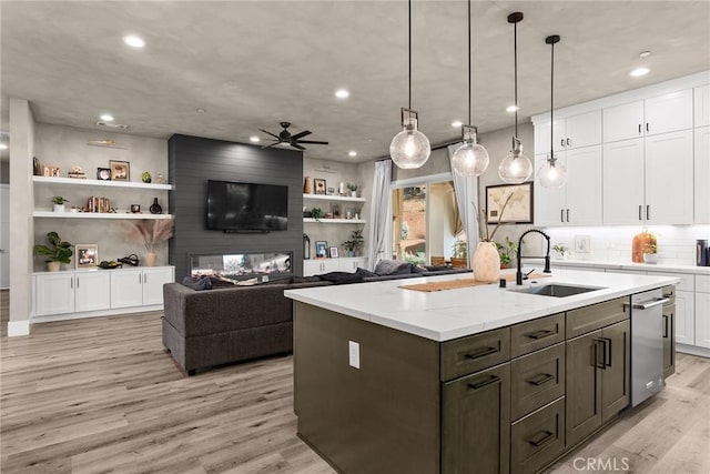 kitchen featuring white cabinets, pendant lighting, light hardwood / wood-style floors, and sink