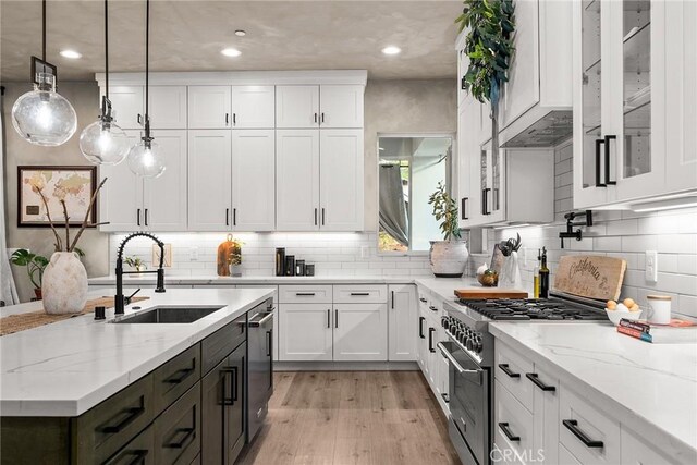 5772 Acorn Ridge Dr, Paradise, CA 95969 - kitchen featuring appliances with stainless steel finishes, white cabinetry, light wood-style floors, pendant lighting, and glass insert cabinets