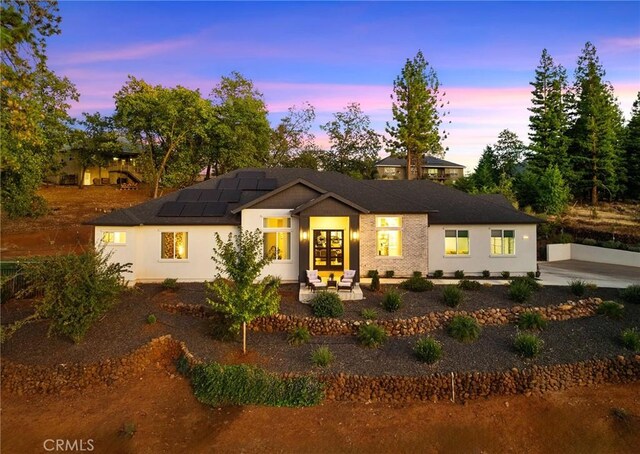 5772 Acorn Ridge Dr, Paradise, CA 95969 - view of front of house featuring solar panels, stucco siding, and a patio