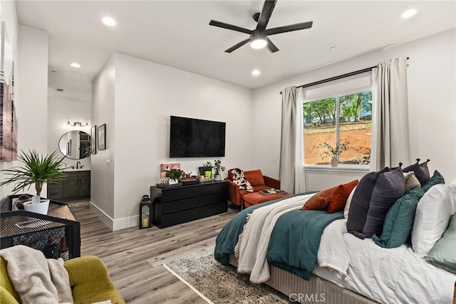 bedroom with ceiling fan and light hardwood / wood-style floors