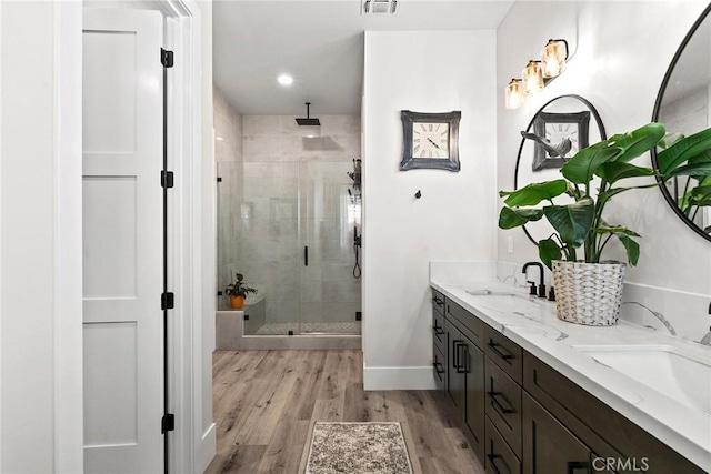 bathroom with vanity, wood-type flooring, and walk in shower