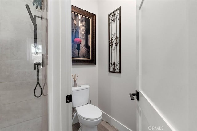 bathroom with hardwood / wood-style flooring and toilet